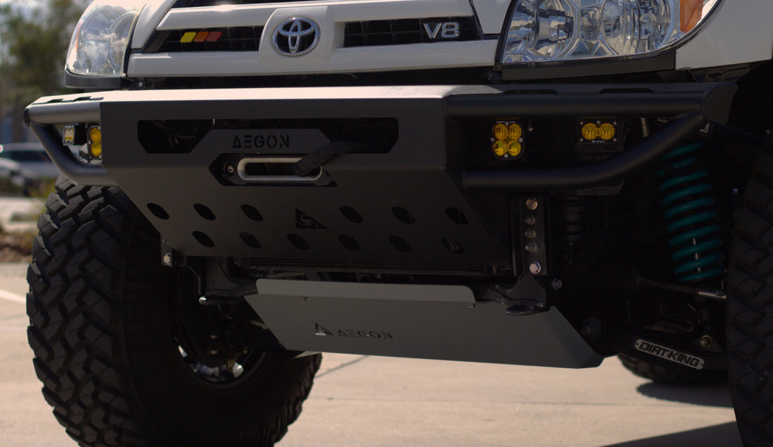 Front view of a 4th Gen Toyota 4Runner with a high-clearance steel bumper on a trail.