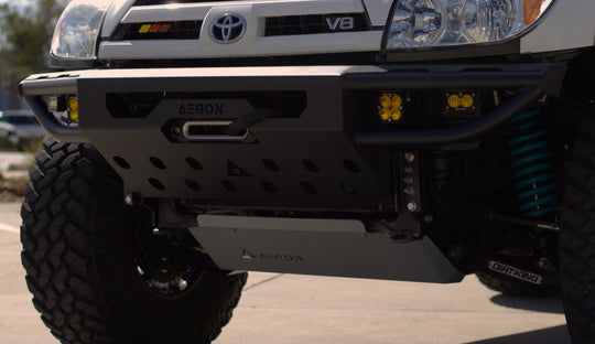 Front view of a 4th Gen Toyota 4Runner with a high-clearance steel bumper on a trail.