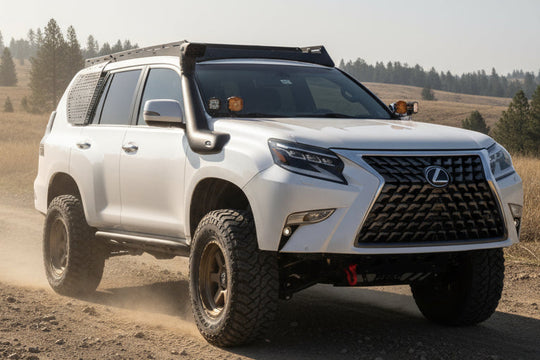 Lifted white Lexus GX460 with AEGON roof rack, snorkel and exterior MOLLE panel on a dirt trail