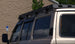 Wind deflector on a Toyota Land Cruiser FJ62 roof rack to reduce noise and drag.