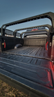 Heavy-duty bed rack featuring multiple tie-down points and integrated mounts for off-road auxiliary lighting.