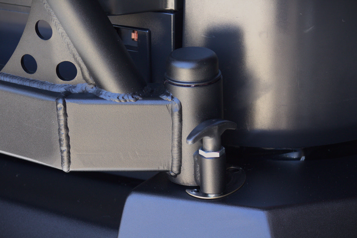 Detail of the welded hinge and locking pop-pin on the AEGON FJ Cruiser swing-out tire carrier