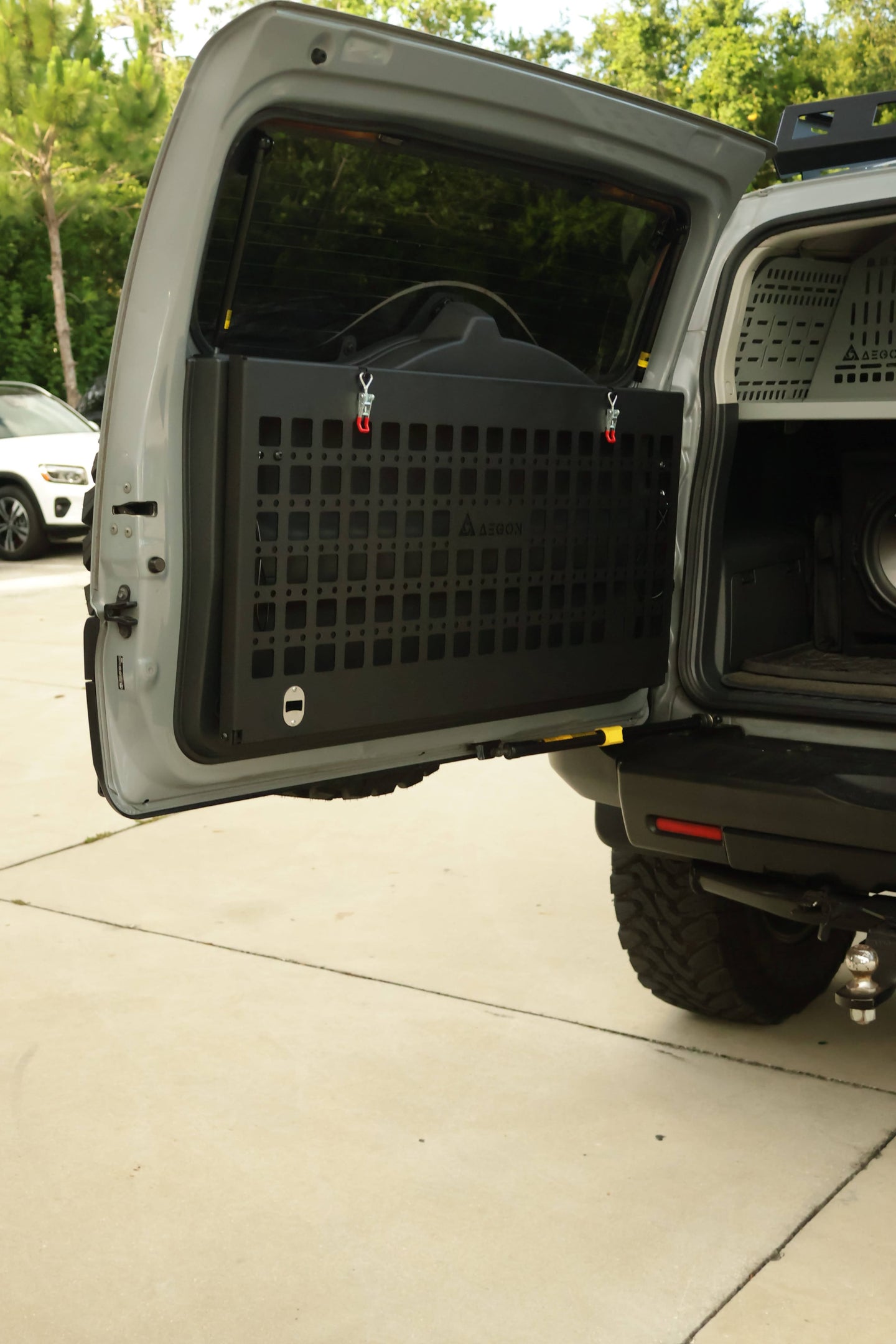 Black powder-coated aluminum Molle panel table for FJ Cruiser supporting up to 120 lbs static load for camping gear.