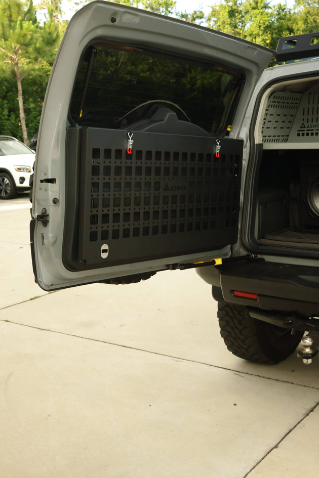 Black powder-coated aluminum Molle panel table for FJ Cruiser supporting up to 120 lbs static load for camping gear.