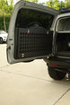 Black powder-coated aluminum Molle panel table for FJ Cruiser supporting up to 120 lbs static load for camping gear.