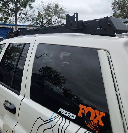 Premium black aluminum roof rack designed for Jeep Grand Cherokee WJ models from 1998 to 2004.
