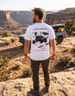 Person wearing the Anatomy of an Overland tee while working on a truck build in a garage.