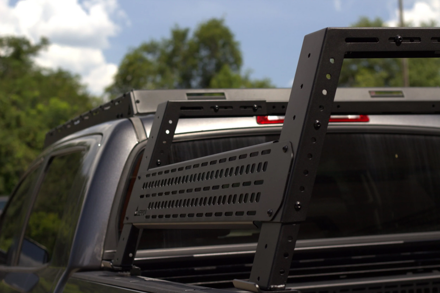 Modular side panels on AEGON bed rack for mounting recovery boards, axes, and shovels.