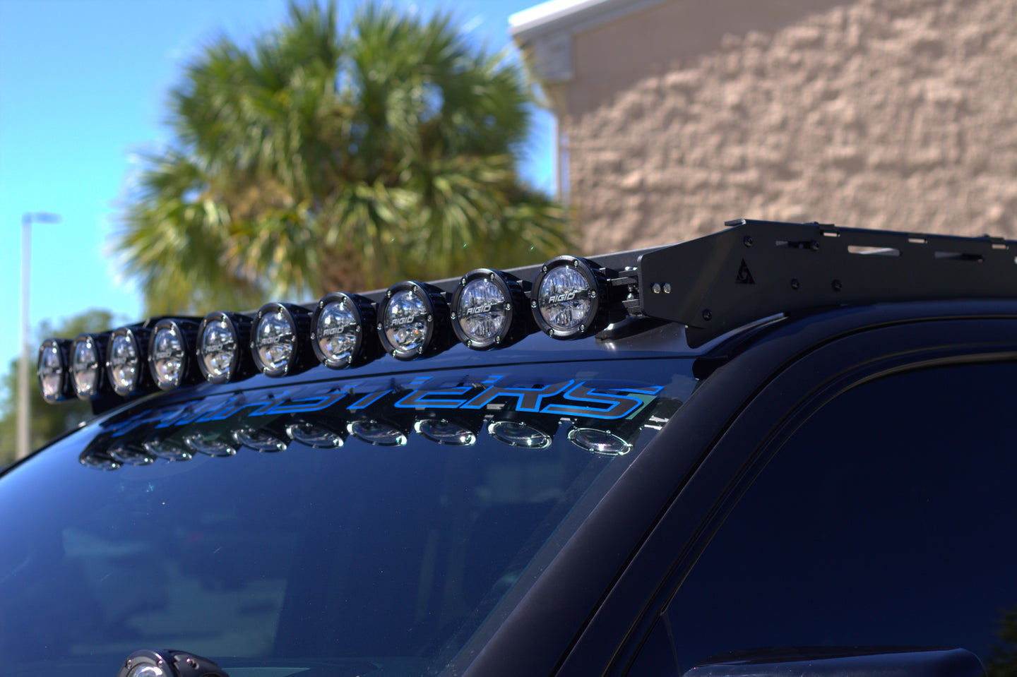 Tactical GMC Sierra 1500 roof rack with built-in front light mounts for off-road LED bars and nighttime trail driving.