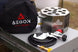 Front view of a portable stainless steel propane fire pit designed for outdoor camping.