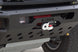 Close-up of a black metal front bumper with a winch mounted on it, featuring the AEGON brand name on the bumper and a winch housing with red and white components.