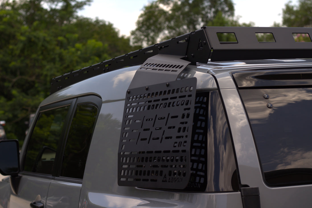 Precision-engineered black steel Molle panel for Toyota FJ Cruiser rear window storage with 1500lb static load capacity.