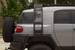 Rear view of a Toyota FJ Cruiser with the AEGON side ladder on the driver side, clear of the spare tire