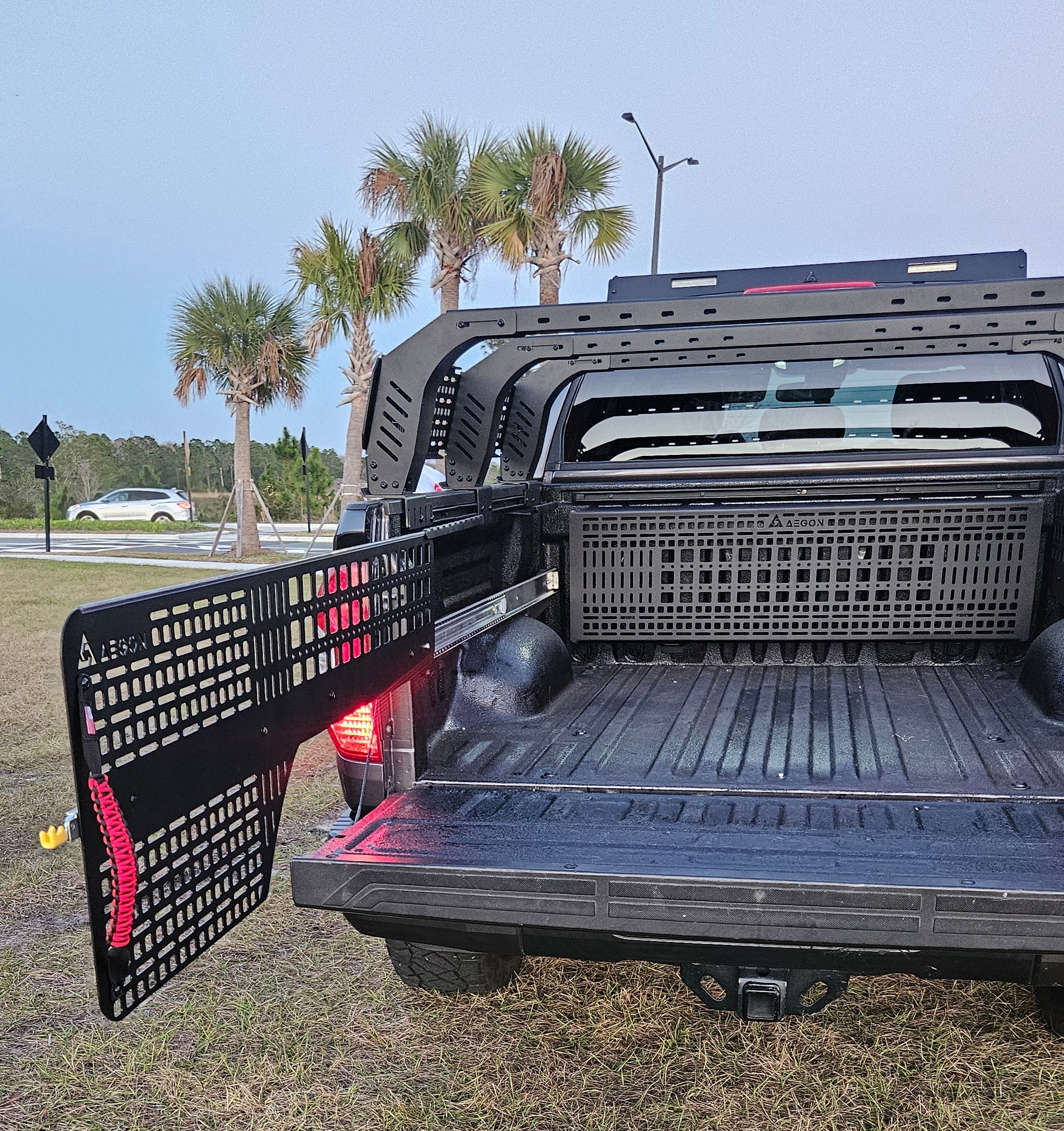 Pull-out Molle bed panel system for Toyota Tundra CrewMax 2007-2021 featuring sliding side rails and static front panel for gear access.