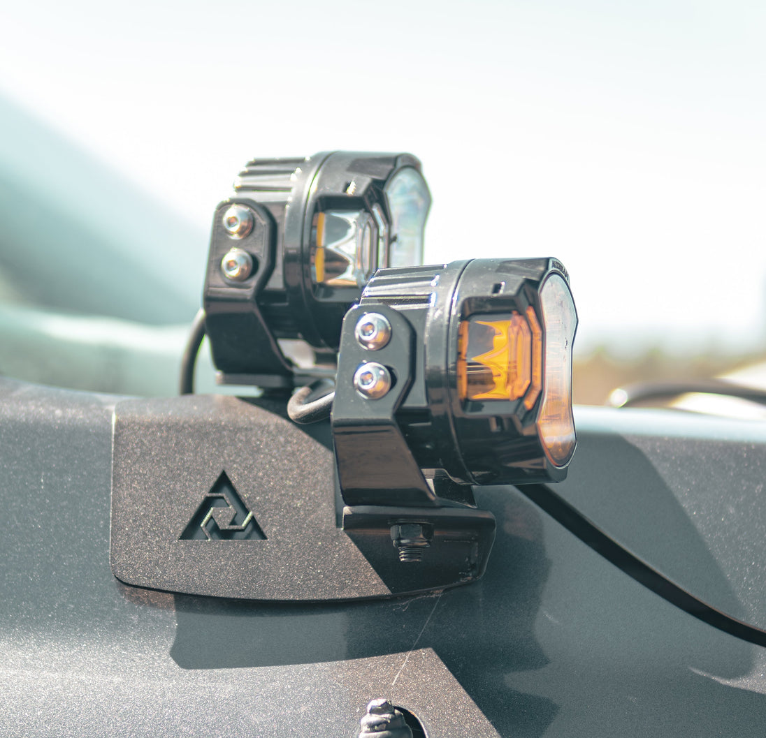 Pair of black steel AEGON hood side light mount brackets for 2007-2021 Toyota Tundra.